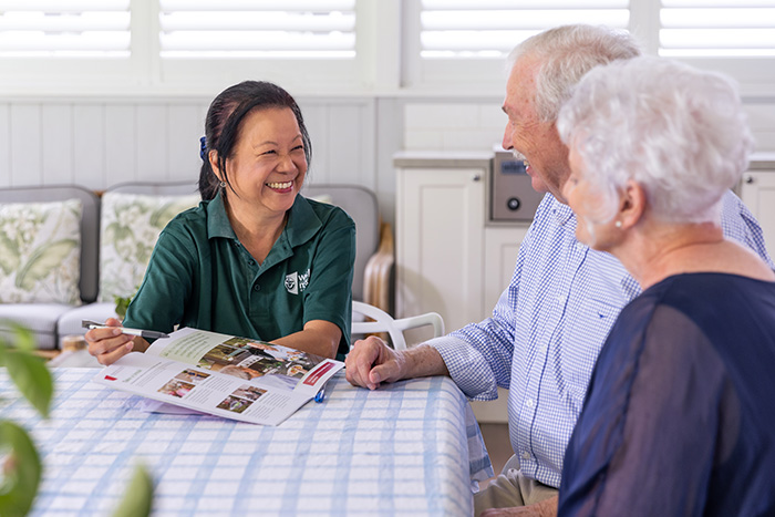 Home Care Brisbane - Staff and couple discussing services and costs 2- WMQ Home Care Brisbane - Staff and couple discussing services and costs