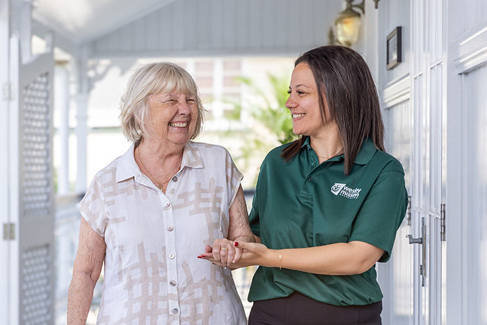 Home Care Brisbane - Staff anf client laughing together - WMQ Home Care Brisbane - Staff and retiree chatting outdoors