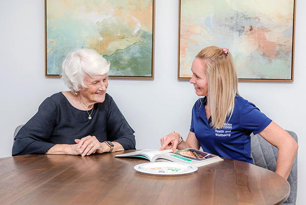 Retiree and staff discussing home and residential aged care services at Wesley Mission Queensland