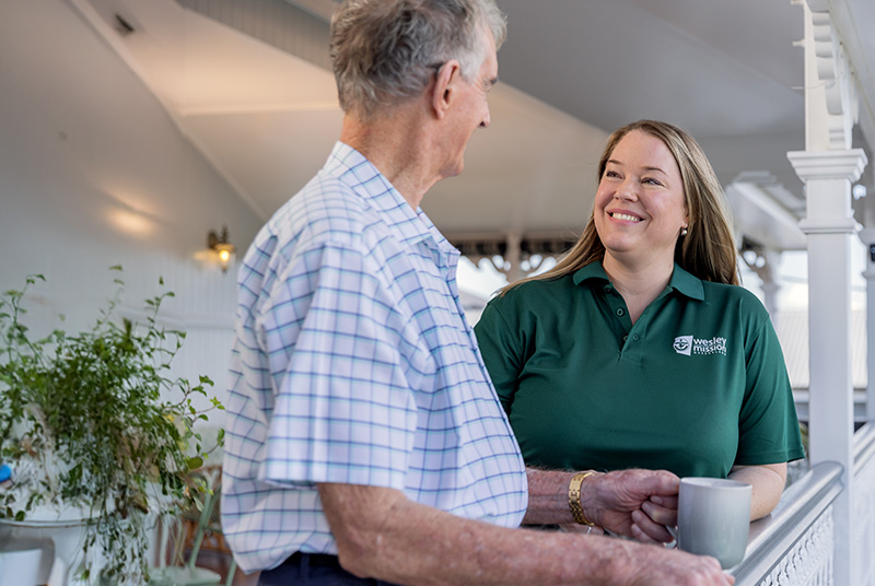 Home Care worker with a client having a cuppa at the balcony