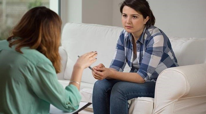 Allied health for mental health Two people sit talking on couches