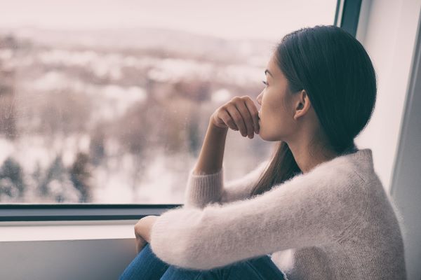 The Way Back Support Service Woman looks out window