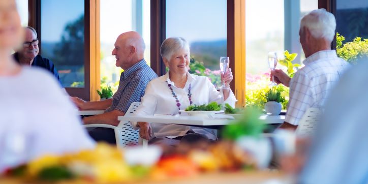 Rosemount cafe with couple sitting down to a meal Couple sitting down at a cafe to a meal and raising their glasses